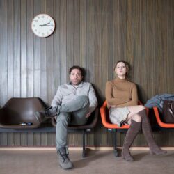 Man and woman sitting on chairs